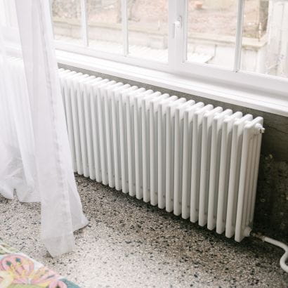 White Delta column radiator below window